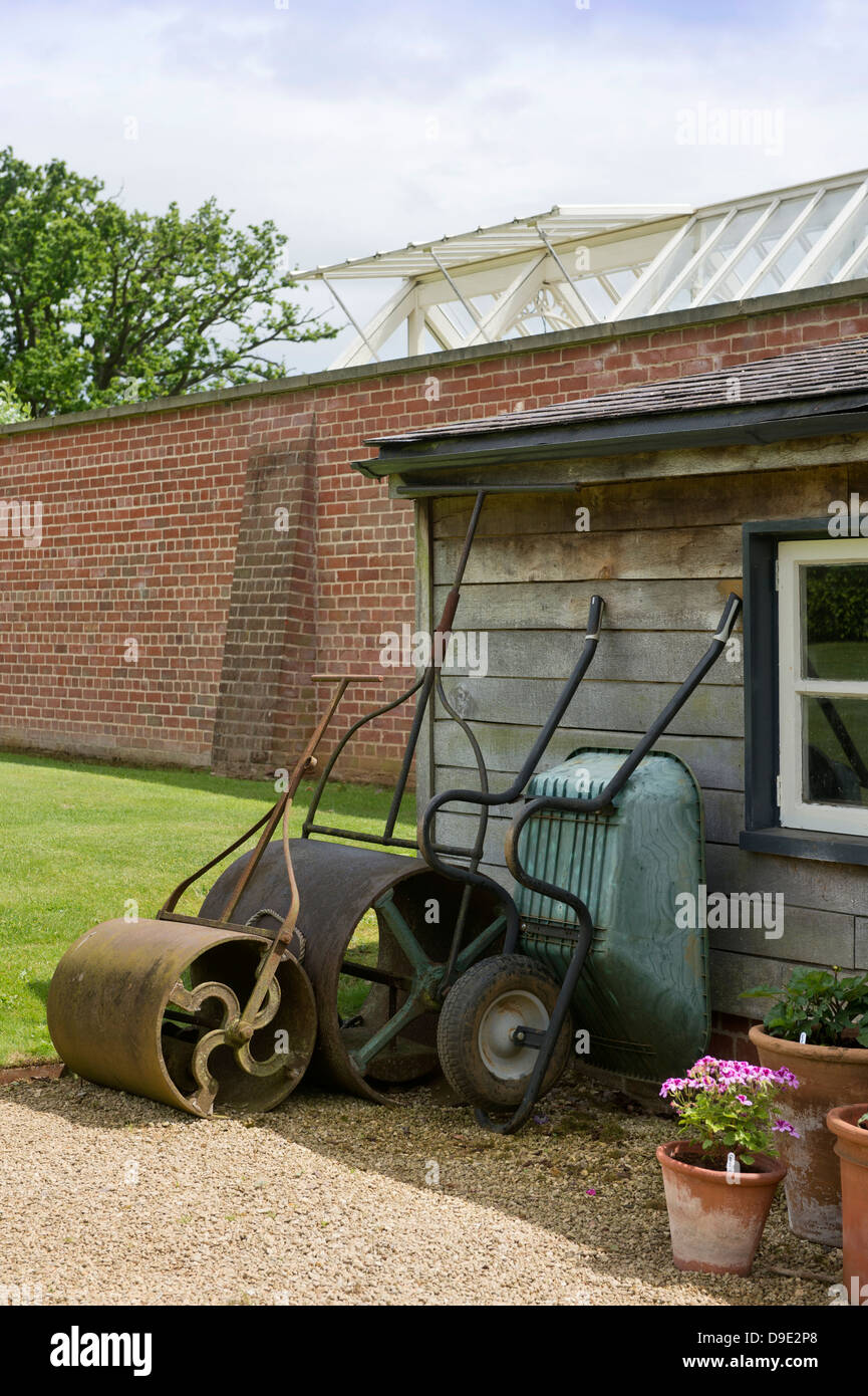 Antique garden lawn rollers in an English garden UK Stock Photo