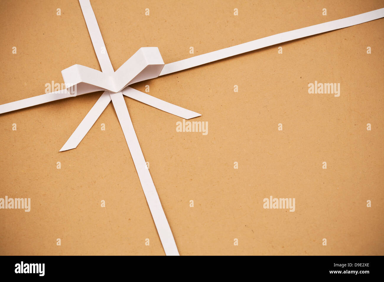 Cardstock Ribbon Paper Hand made ribbon and bow on kraft paper as background. Greeting card ...