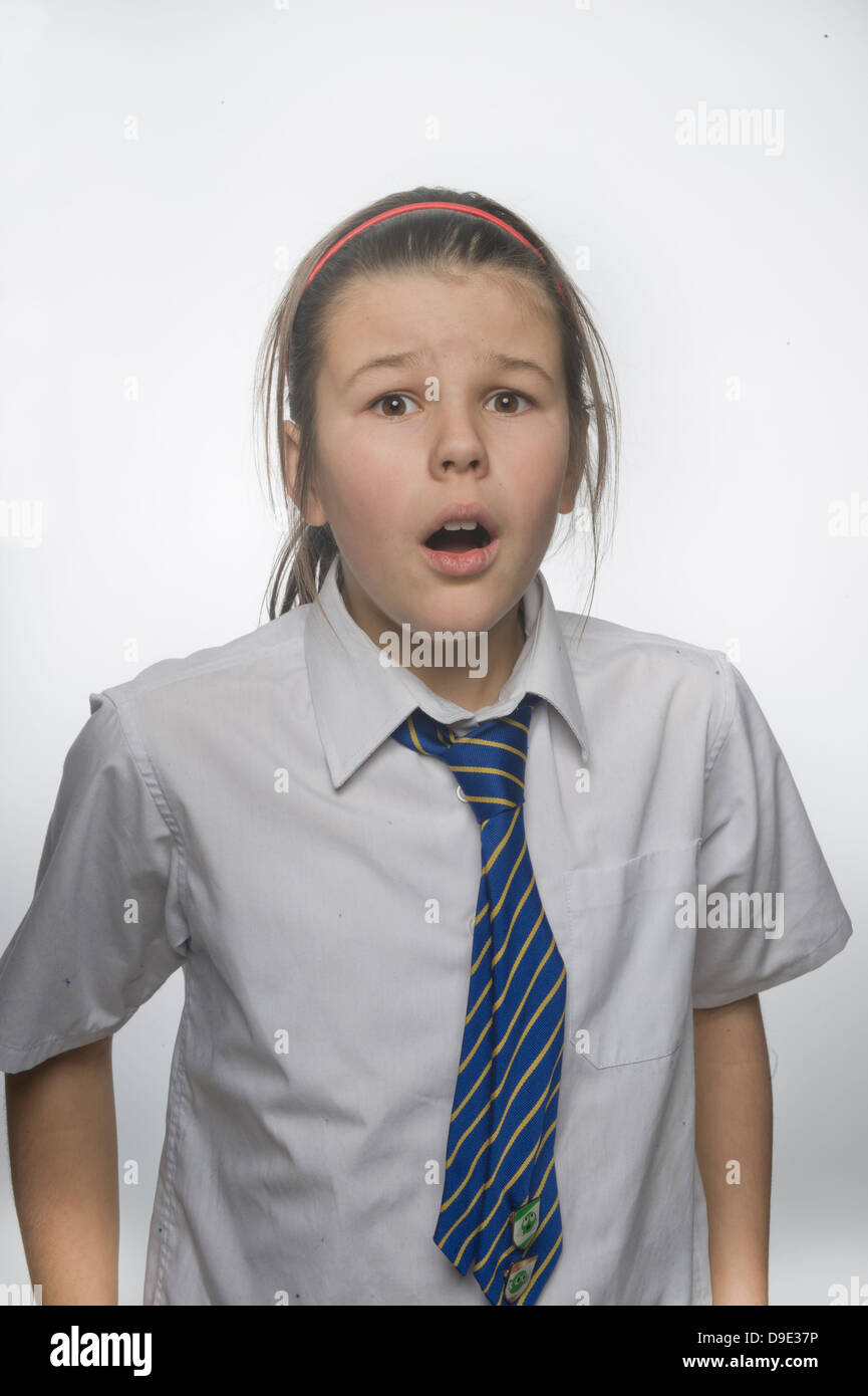 Young schoolgirl, new form against a white background, shocked, angst anxious unbelieving Stock Photo