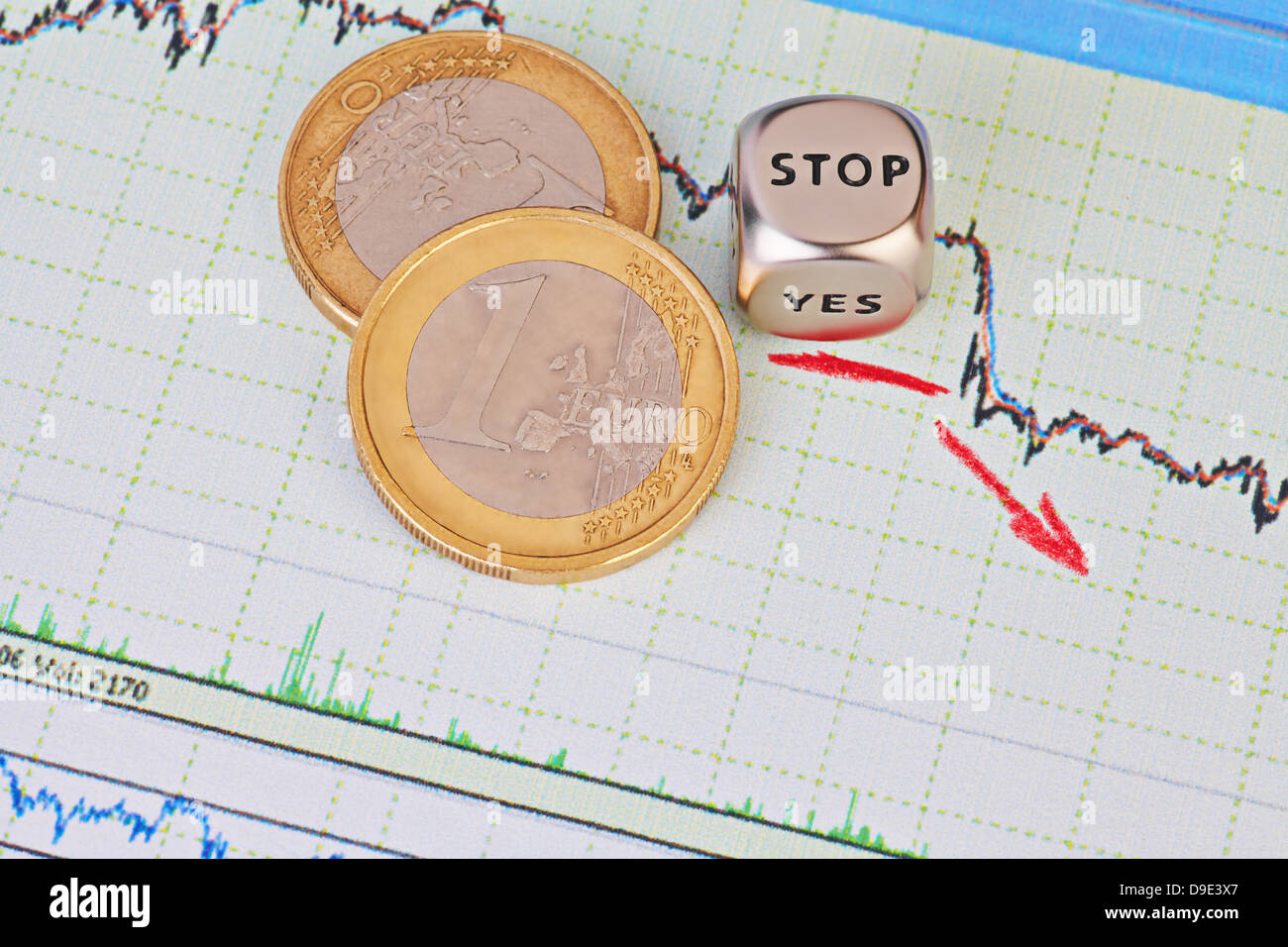 Downtrend financial market chart, red arrow, dices cube with the word STOP and one-euro coins. Selective focus Stock Photo