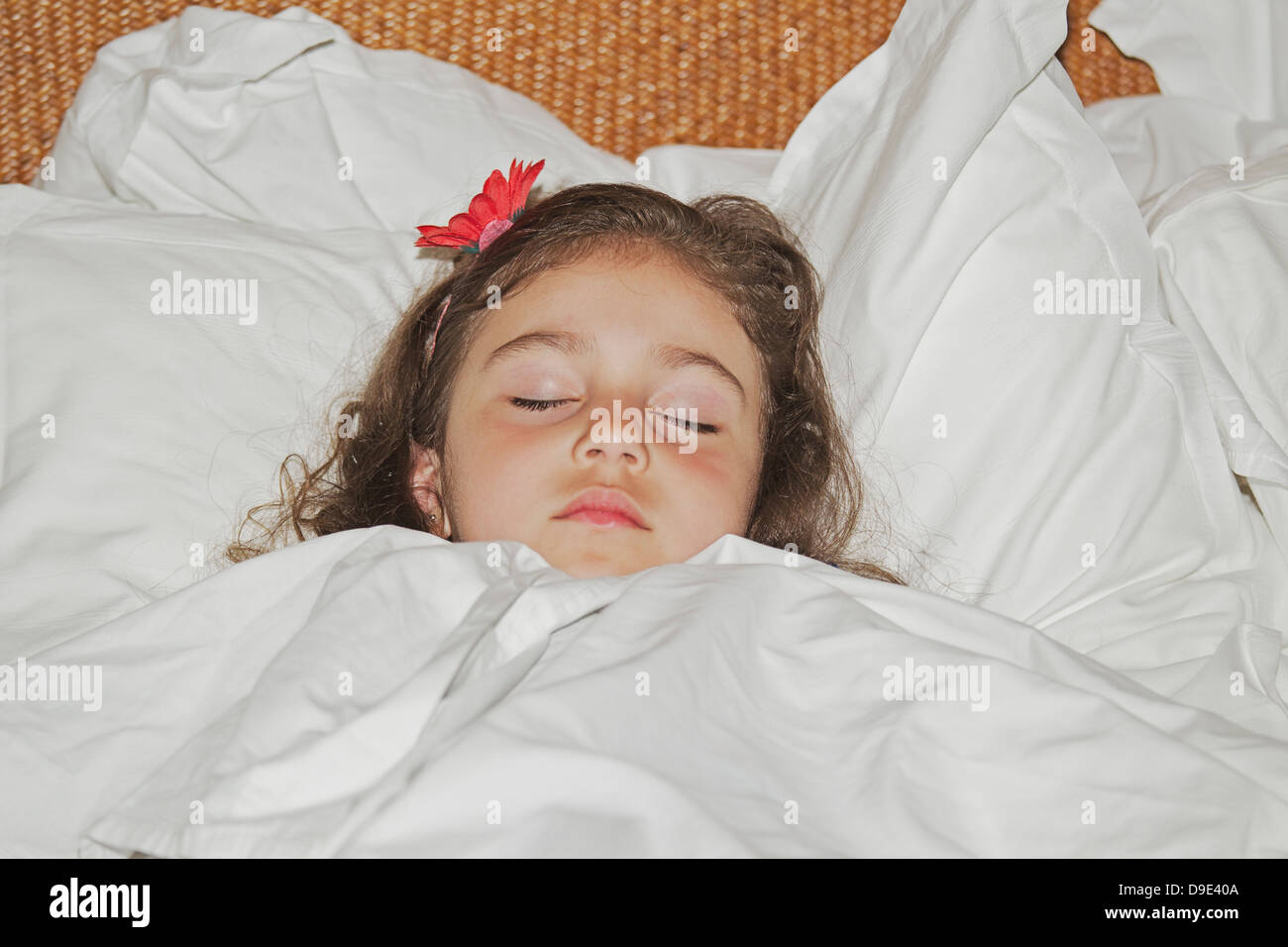 Girl sleeping in white bedding Stock Photo - Alamy