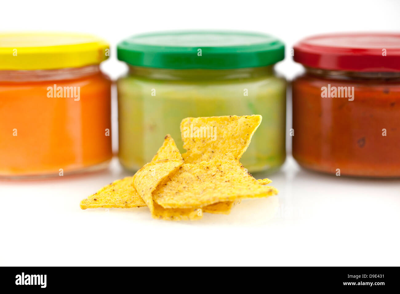 Traditional nacho chips and Mexican dips isolated on white background Stock Photo