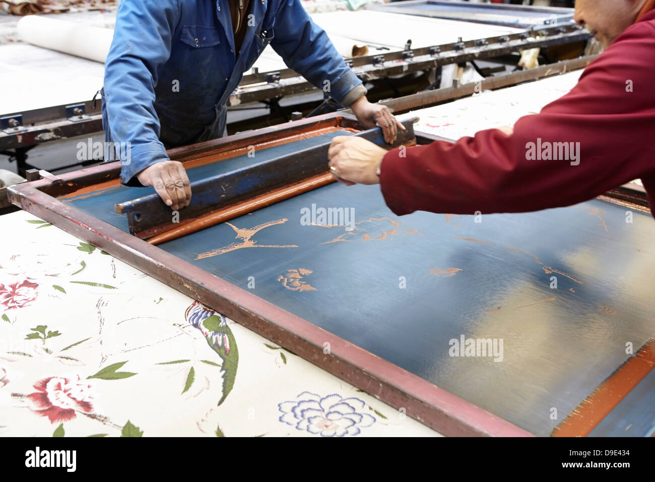 Two men screen printing in textiles factory Stock Photo Alamy