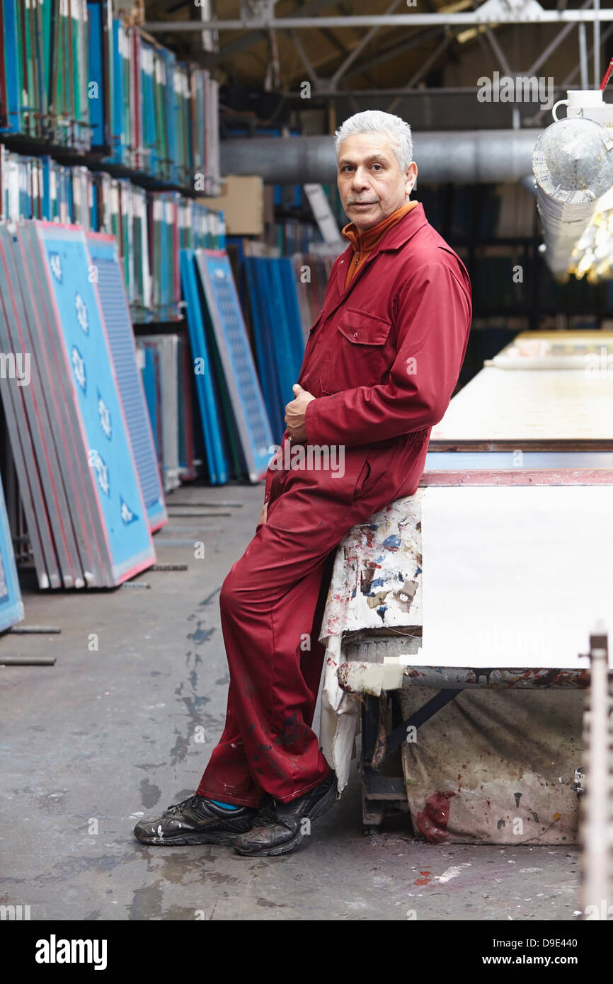 Portrait of man wearing boiler suit in screen printing factory Stock Photo
