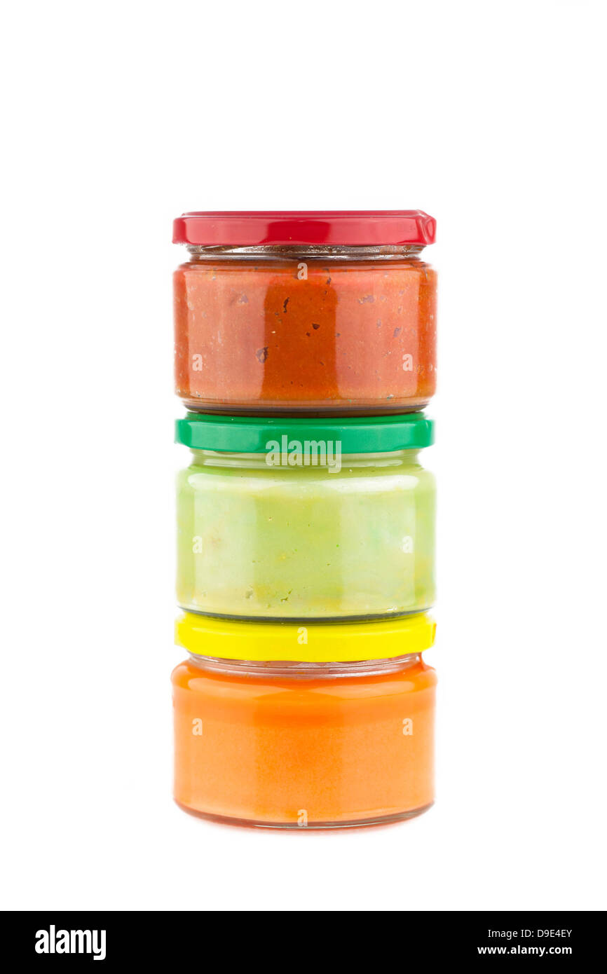 Traditional Mexican dips made of cheese, guacamole and tomato chutney in jars. Stock Photo
