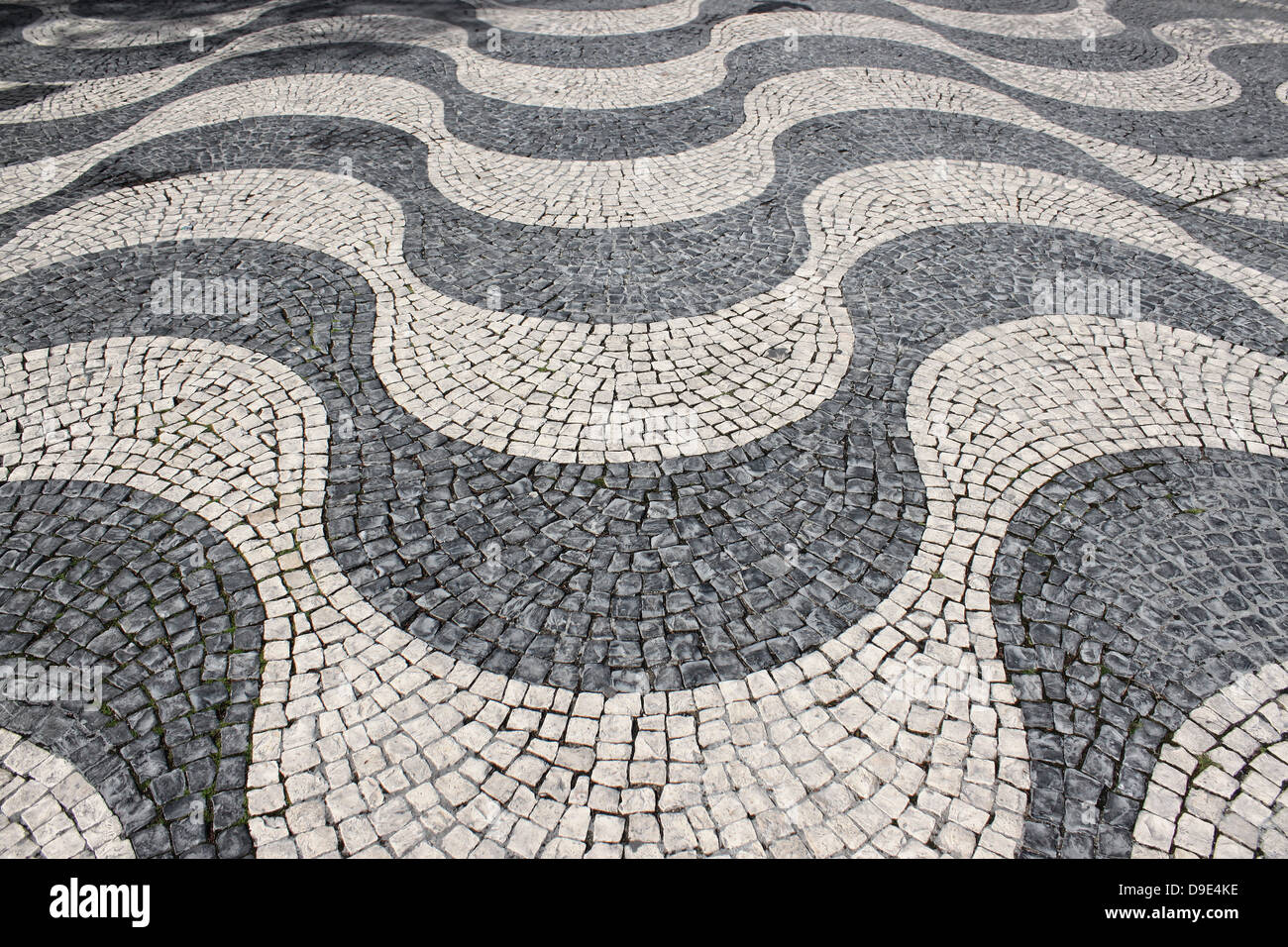 Wave pattern design in cobblestone covered square in Portugal Stock Photo