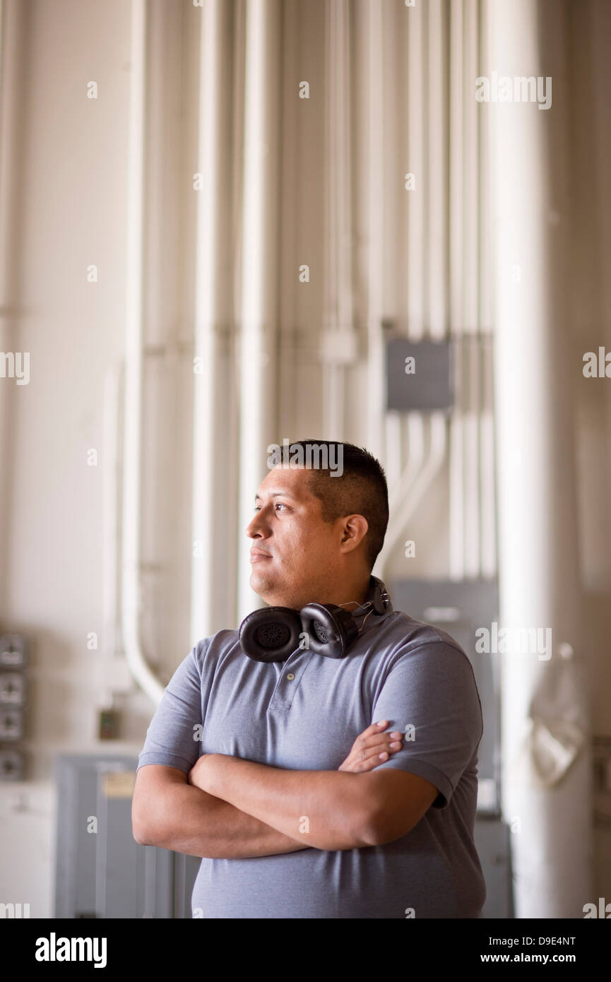 Male warehouse worker with headphones around neck Stock Photo Alamy