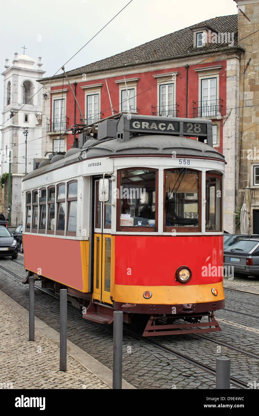 Historic number 28 red tram or streetcar on the cobblestone streets of Alfama, Lisbon, Portugal Stock Photo