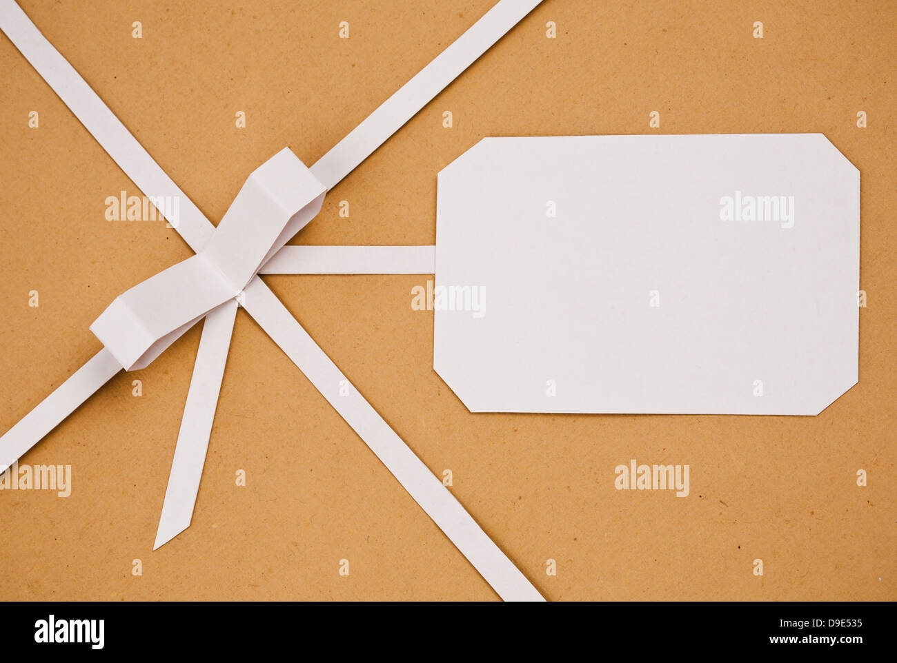 Hand made ribbon with bow and heart on kraft paper as background ...