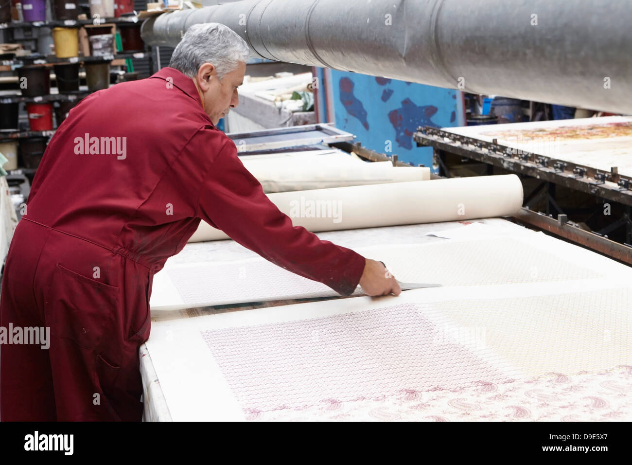 Man cutting fabric in textiles factory Stock Photo
