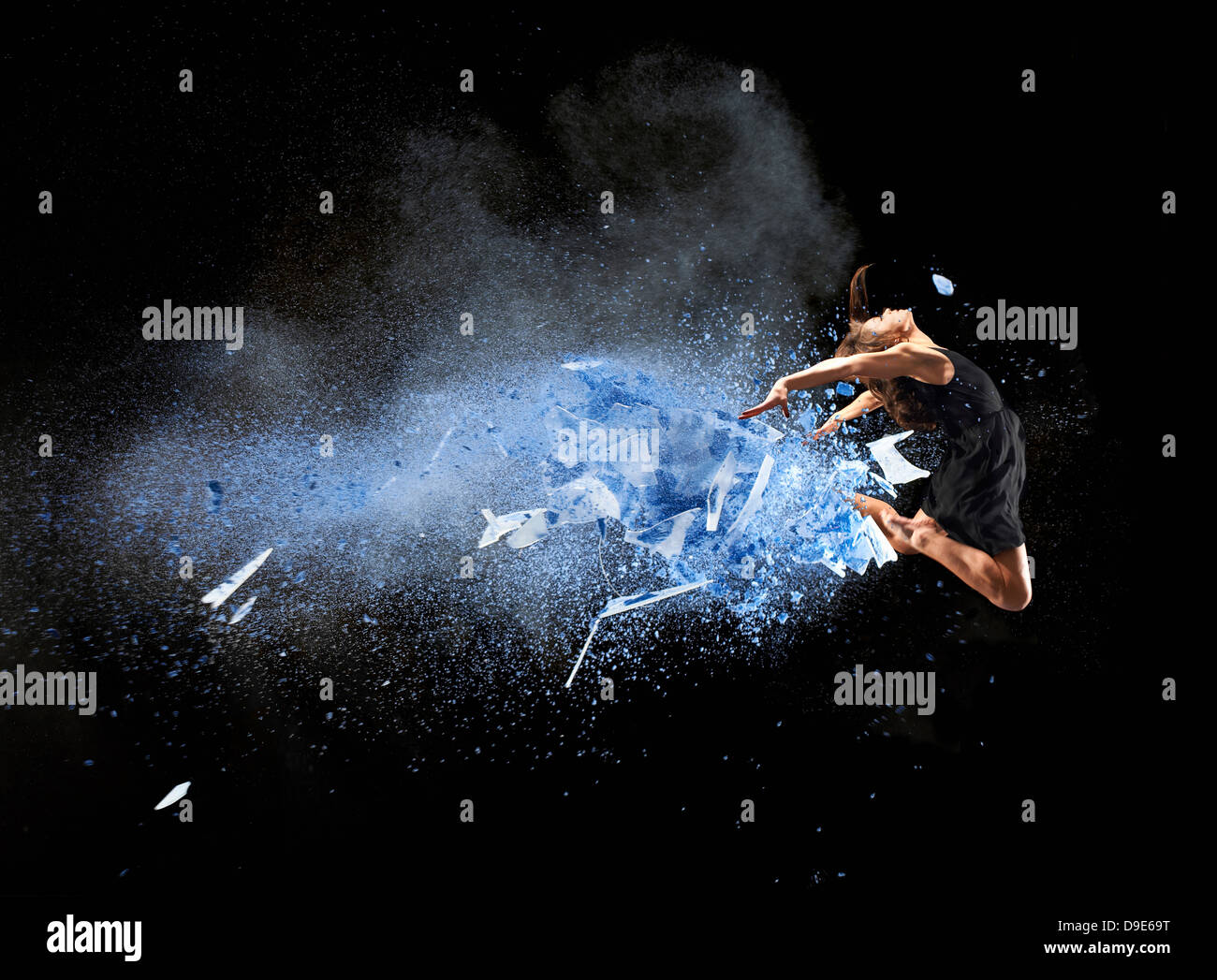 Female dancer mid air with blue powder explosion Stock Photo - Alamy
