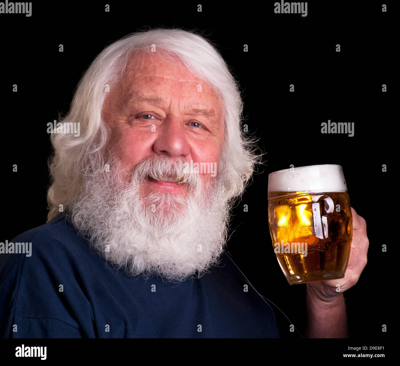 Beer - bearded man drinking a beer outside the pub Stock Photo