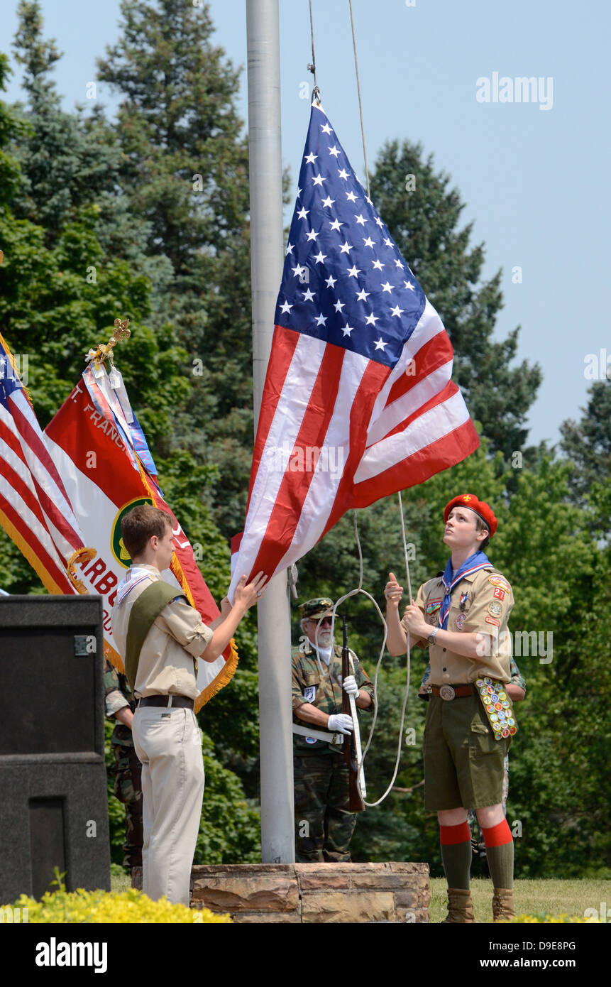 Boy scouts raise the flag at the Memorial Day observance on May 27, 2012 at Arborcrest Memorial Park in Ann Arbor, MI Stock Photo