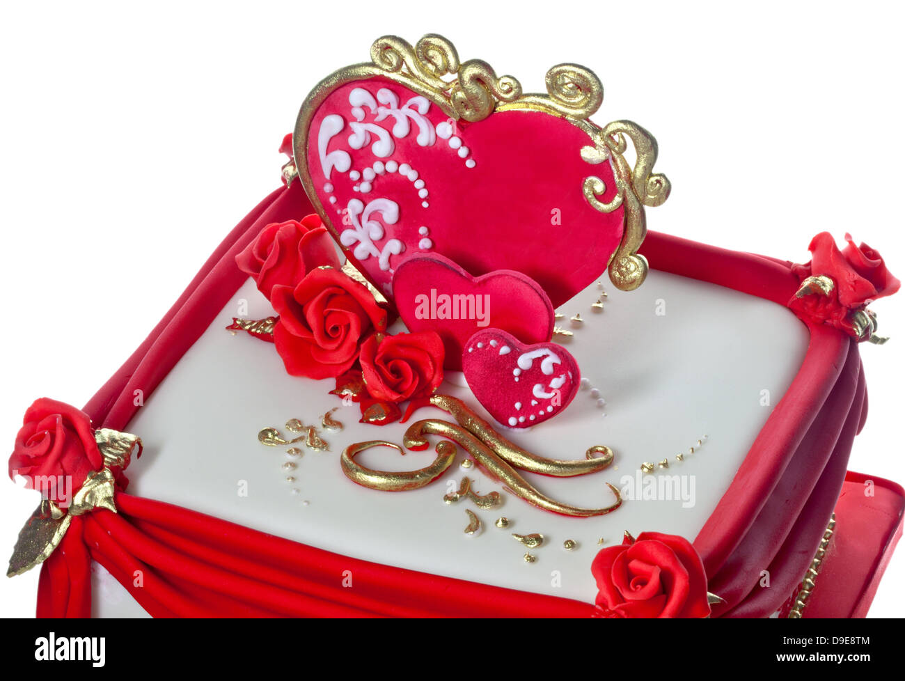 Red, white and gold iced cake decorated with hearts and roses. Stock Photo