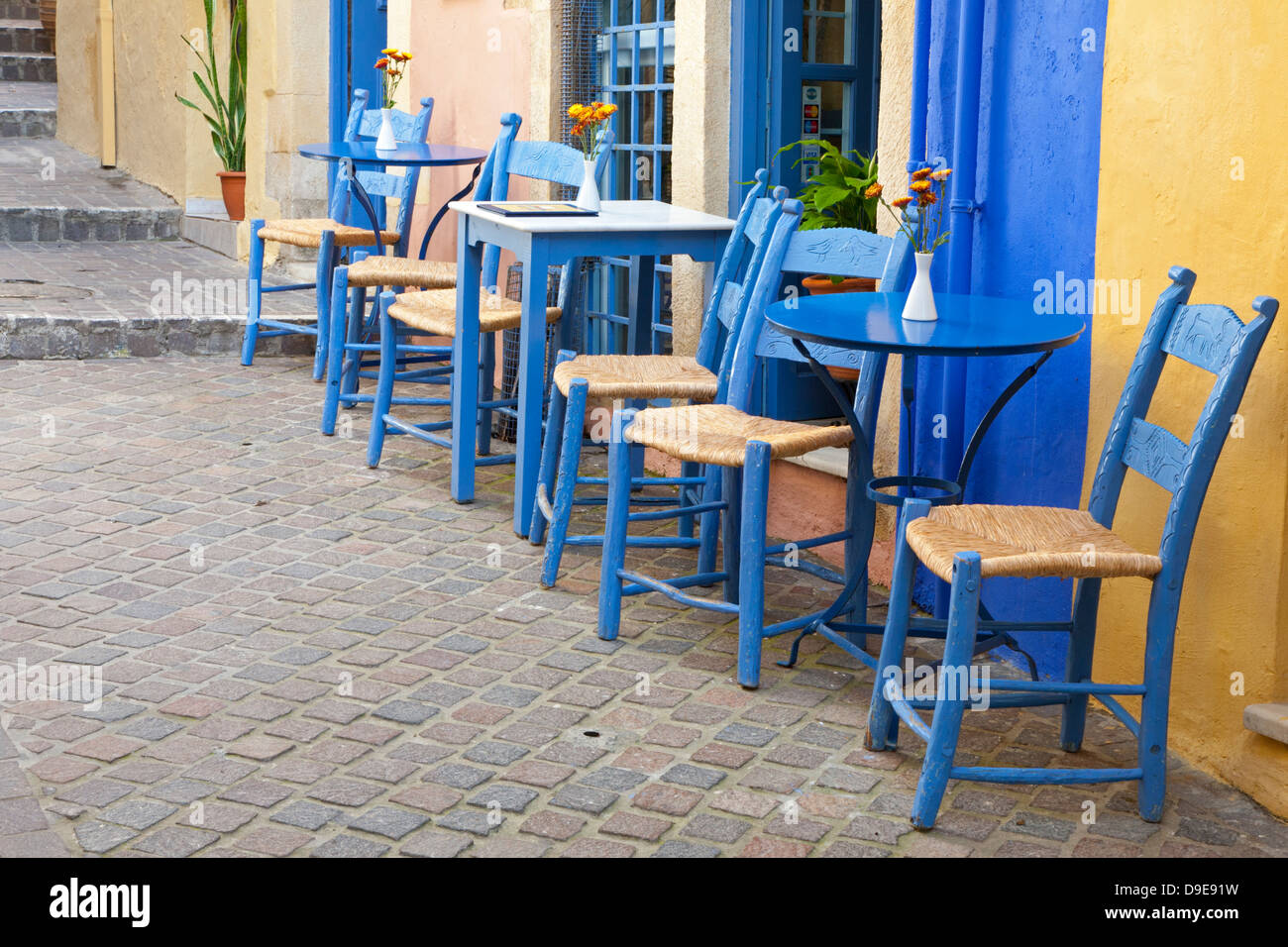 Small inviting cafe at Nostos Hotel with tables and chairs on an