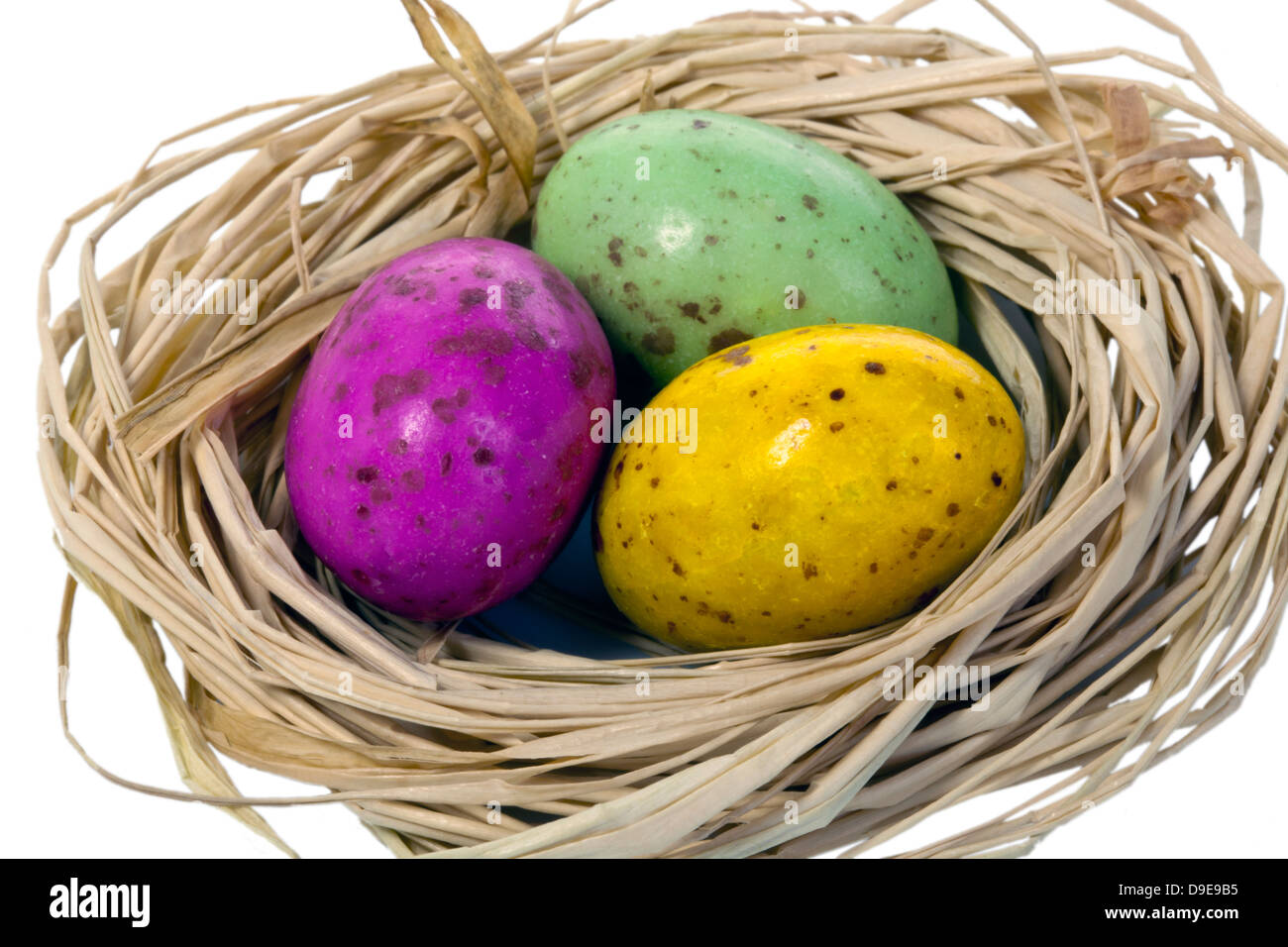 Colourful trio of Easter eggs in a nest Stock Photo - Alamy