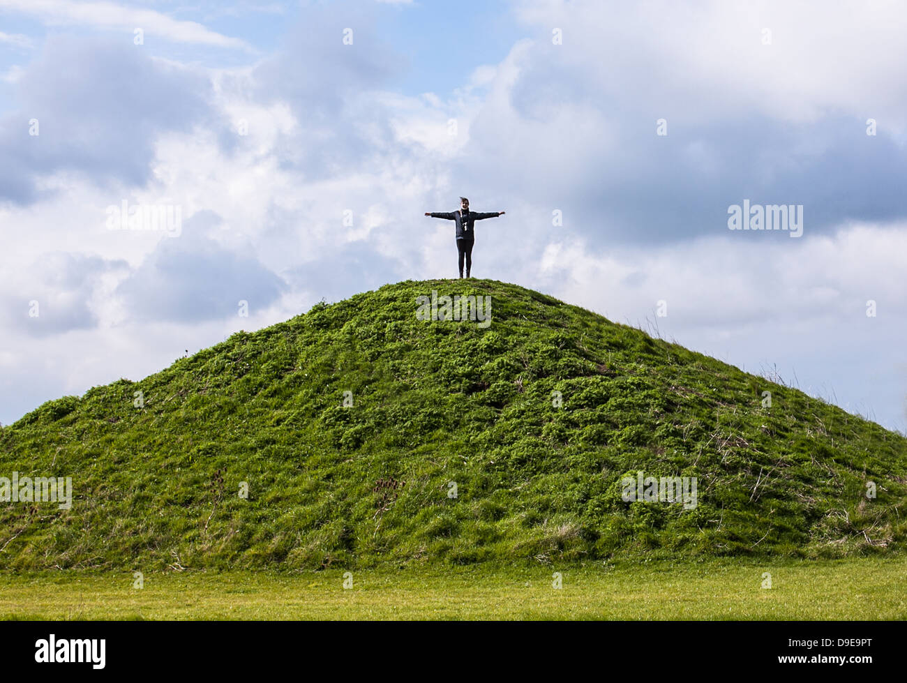 Girl standing on top of a hill Stock Photo - Alamy