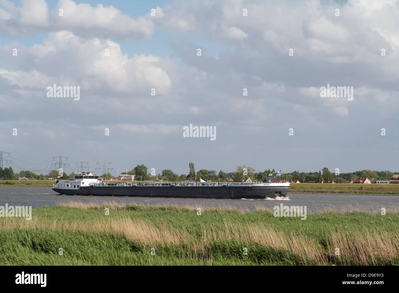 Cargo ship sails on the river in Rotterdam, Netherlands Stock Photo