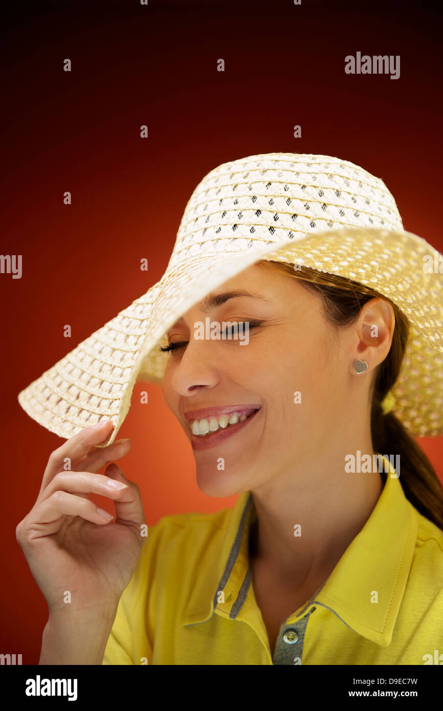 Happy carefree woman straw hat hi-res stock photography and images - Alamy