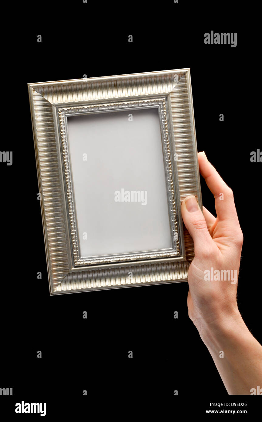 hand holding blank picture frame Stock Photo