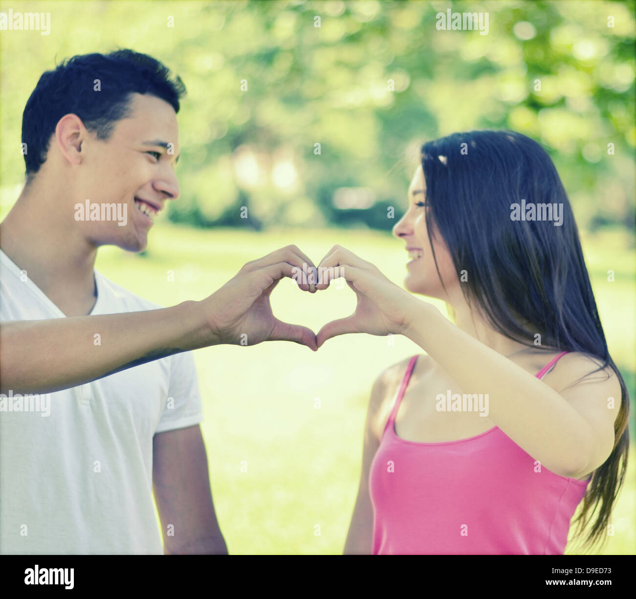 Retro image of couple making heart shape with hands in park Stock Photo ...