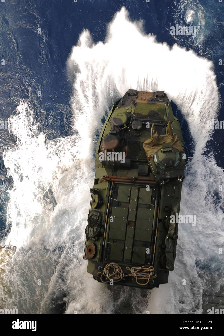 An amphibious assault vehicle exits the well deck of USS Essex. Stock Photo