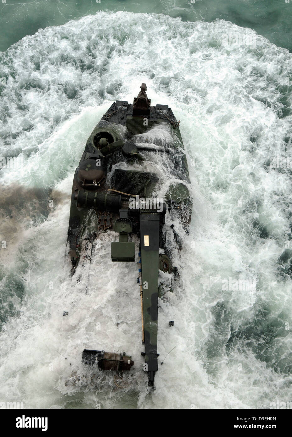 An amphibious assault vehicle leaves the well deck of USS Iwo Jima. Stock Photo