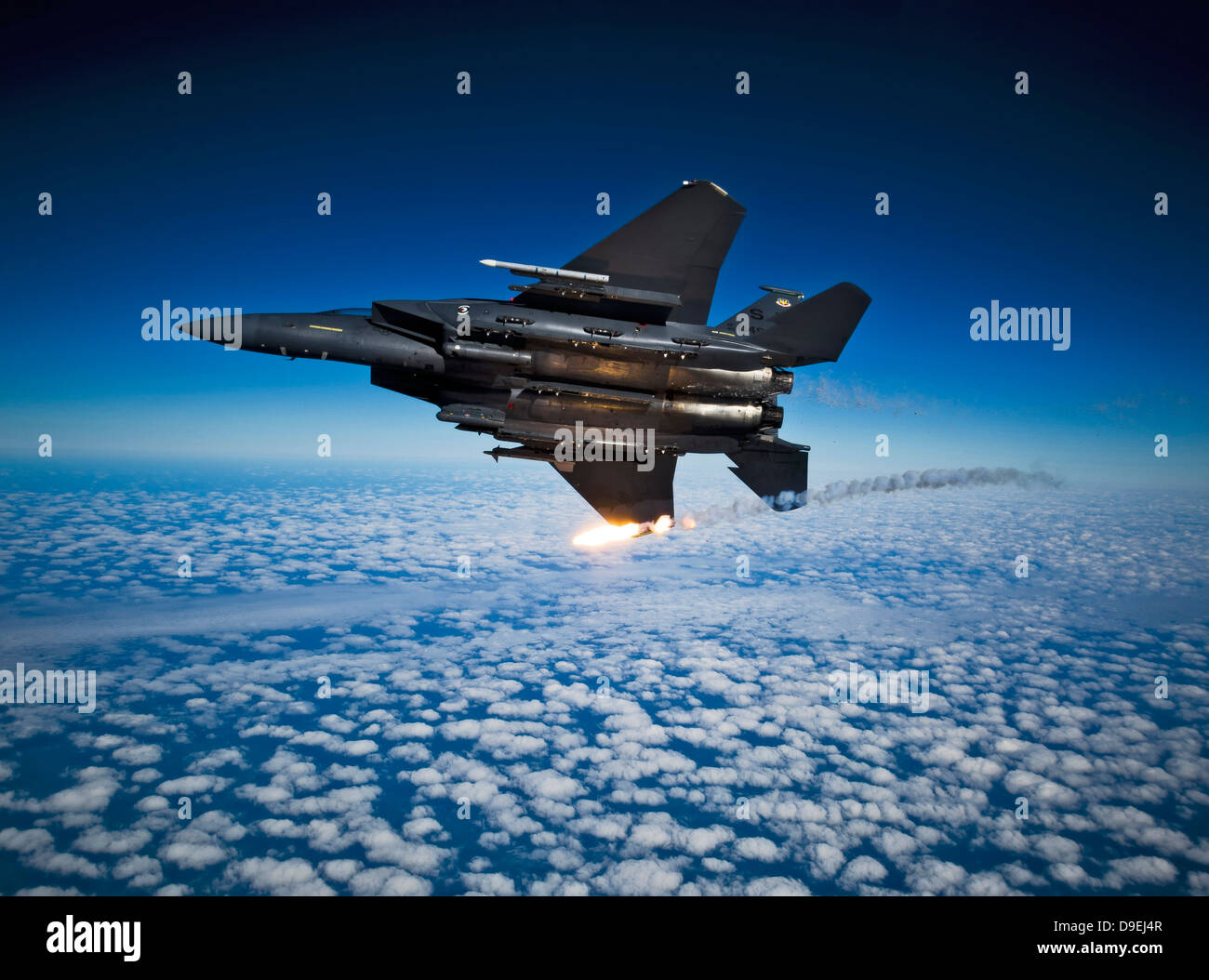 A F-15E Strike Eagle aircraft releases flares. Stock Photo