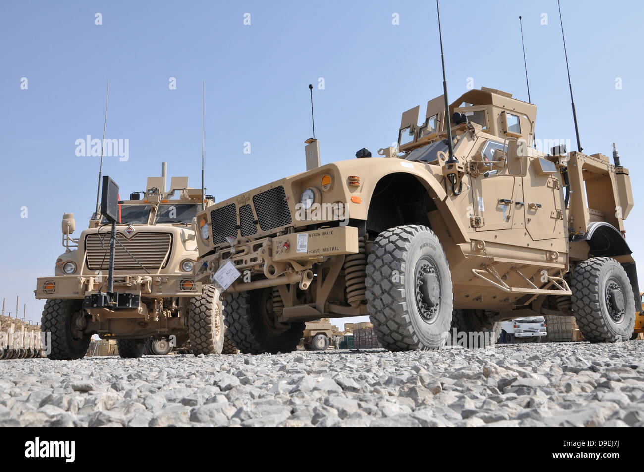 An M-ATV Mine Resistant Ambush Protected vehicle parked next to a MaxxPro MRAP. Stock Photo