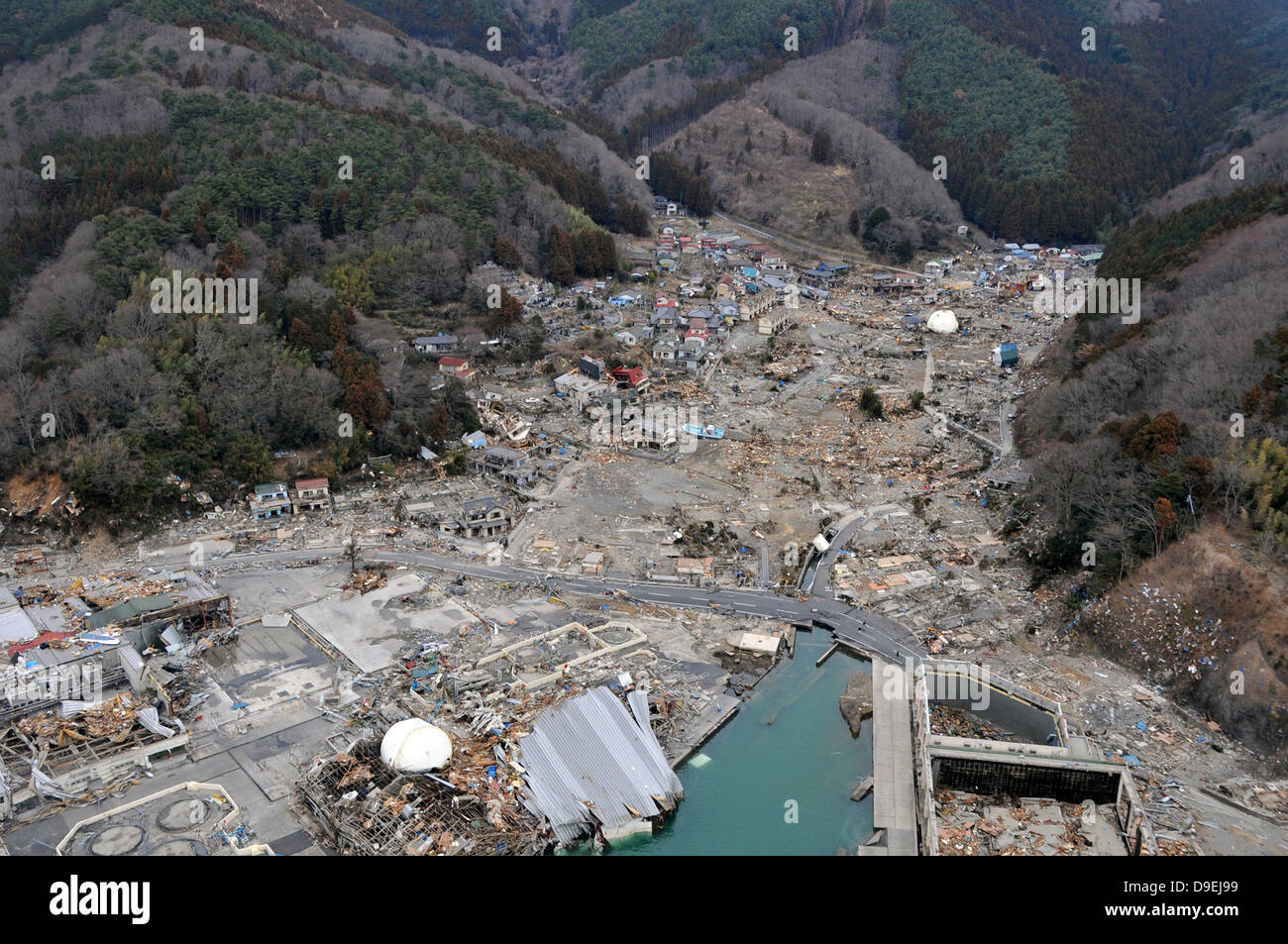 A helicopter team surveys the tsunami and earthquake damage over Japan. Stock Photo