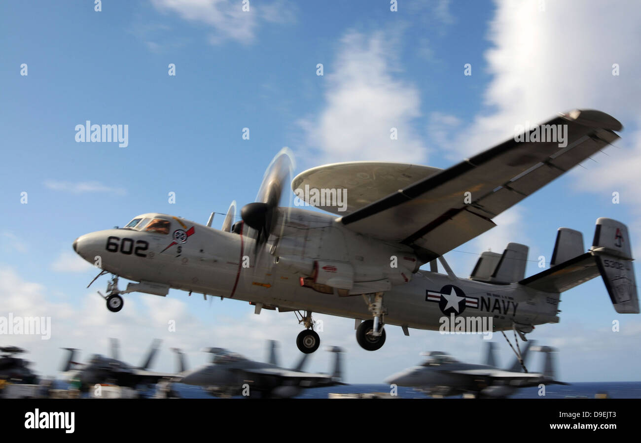 An E-2C Hawkeye lands aboard the aircraft carrier USS George H.W. Bush Stock Photo