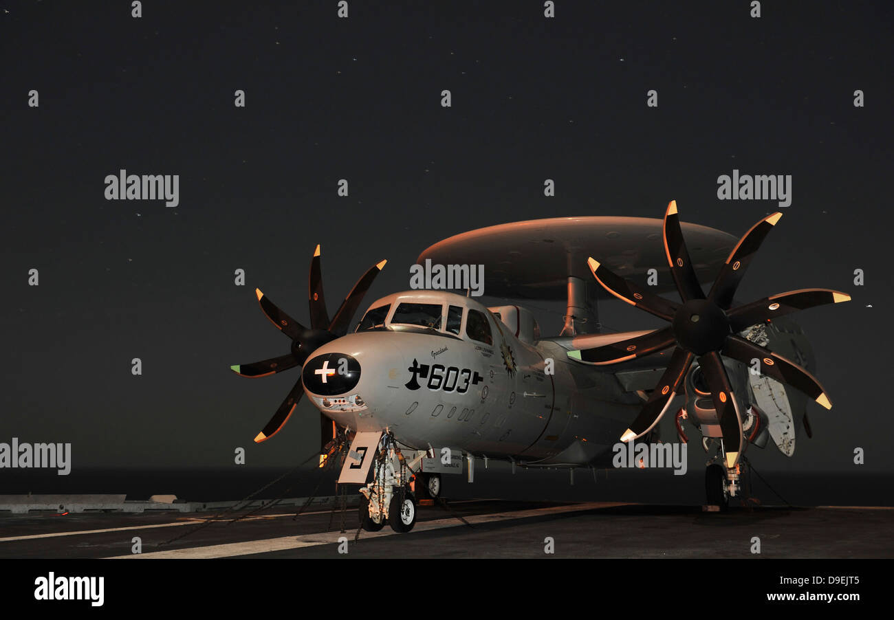 An E-2C Hawkeye is chained to the flight deck aboard USS Abraham Lincoln. Stock Photo