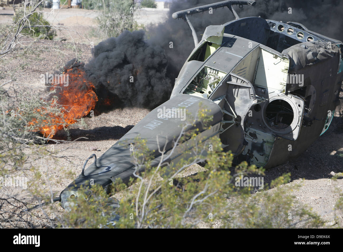 Black smoke rises to the air from a simulated wreckage of a downed UH-1N Huey. Stock Photo