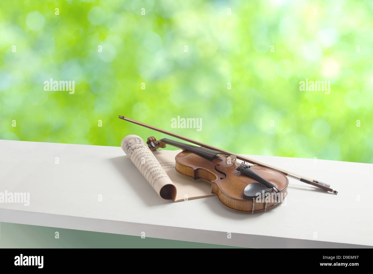 Violin and music sheets by the window Stock Photo