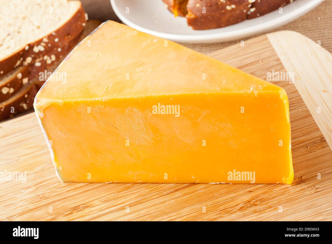 Traditional Yellow Cheddar Cheese on a background Stock Photo