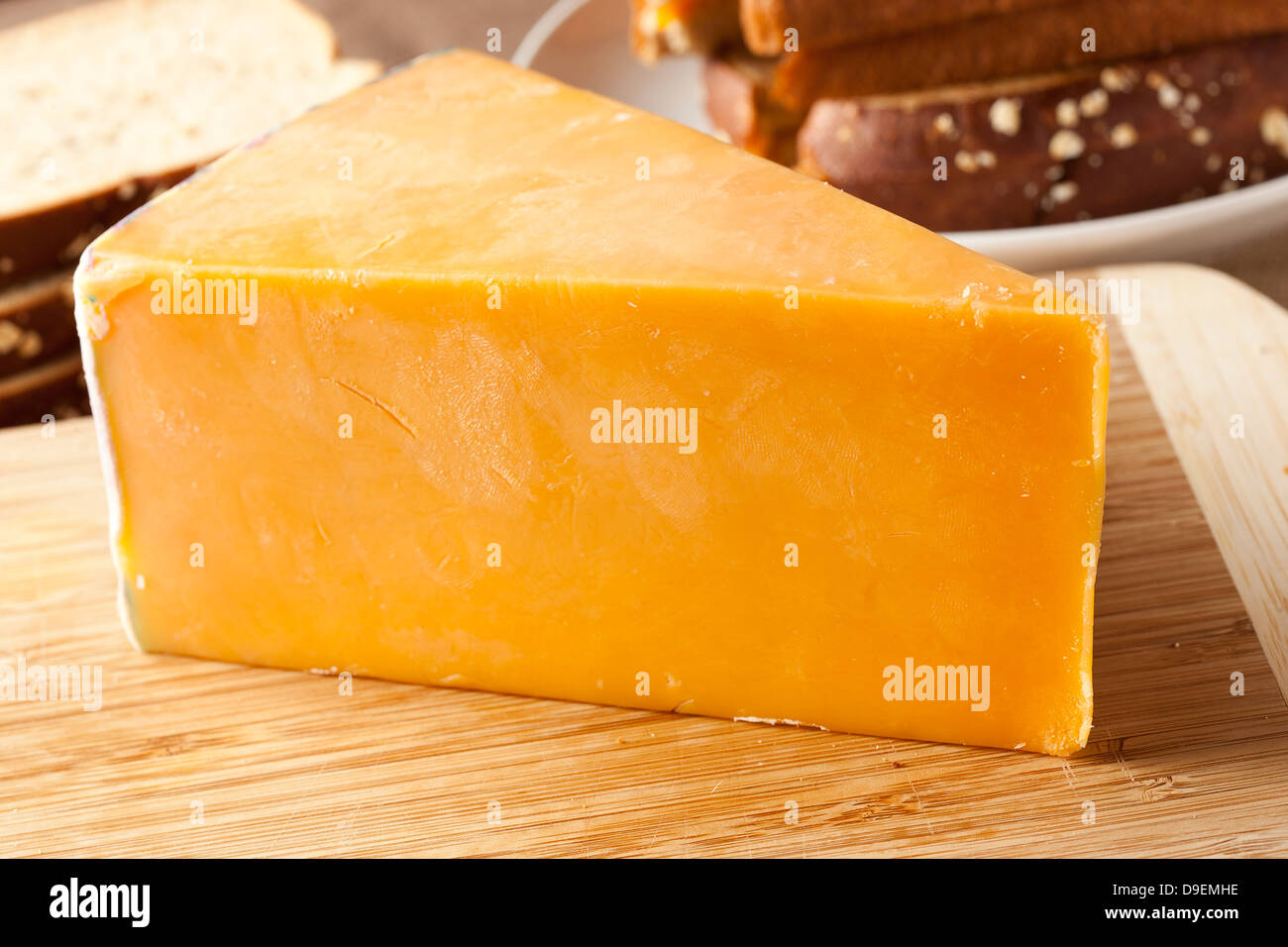 Traditional Yellow Cheddar Cheese on a background Stock Photo