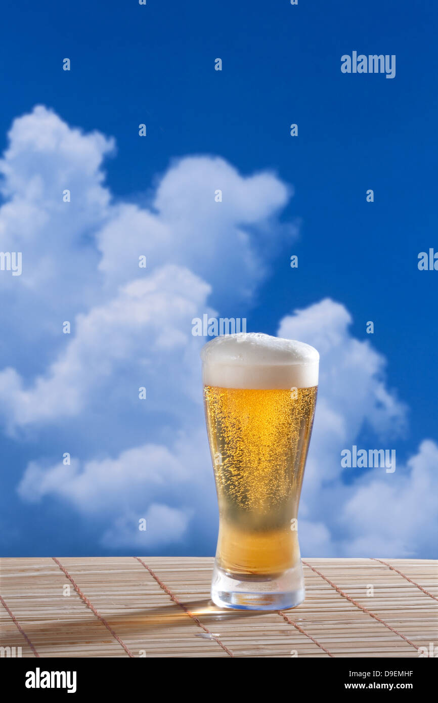 Beer and blue sky with clouds Stock Photo