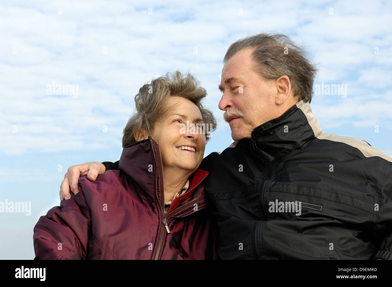 Senior citizen's pair, happily and in love, in autumnal clothes.  (Model release) Stock Photo