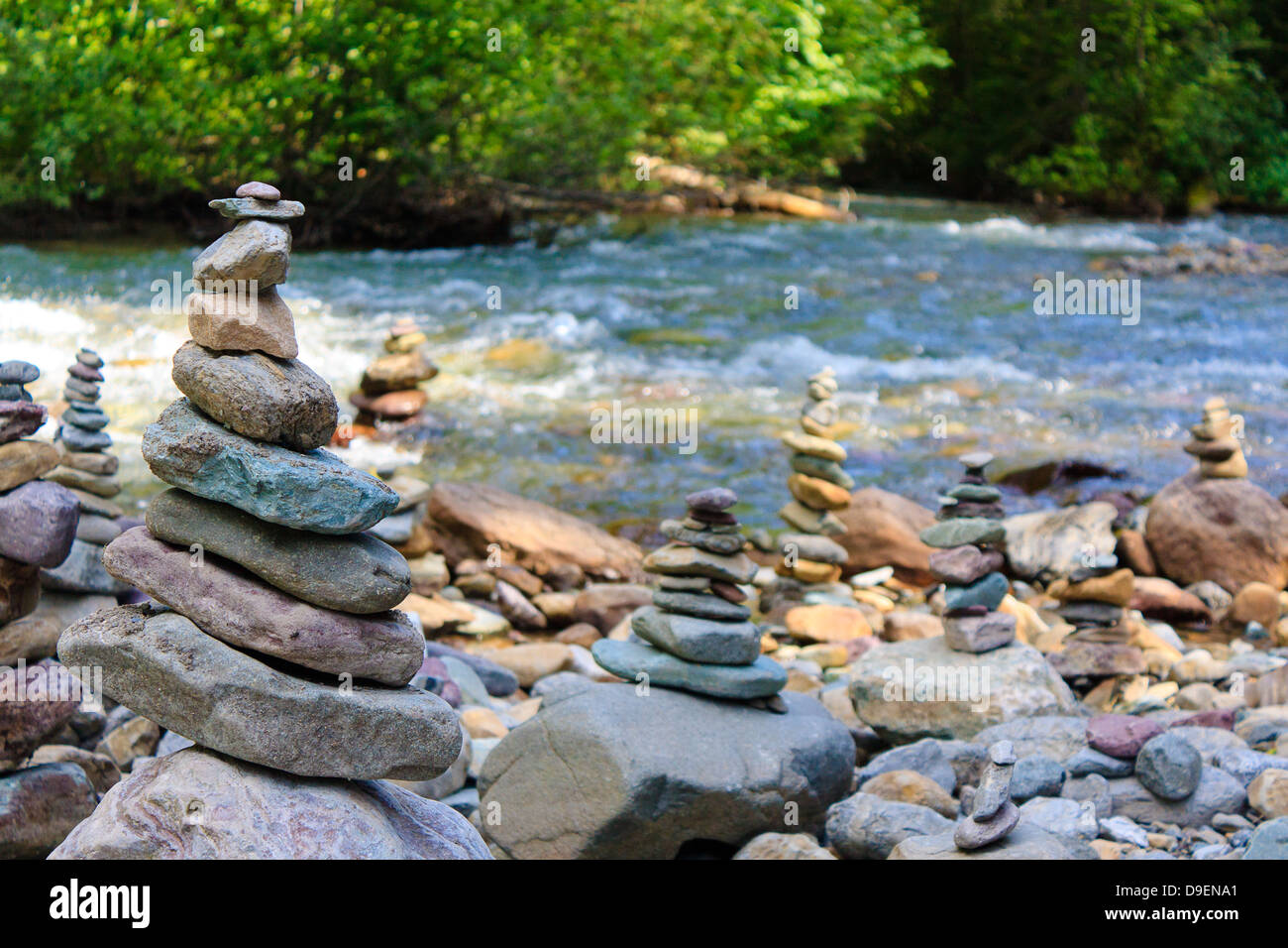 Multiple small cairns along banks of Avalanche Creek in Glacier National Park, Montana Stock Photo