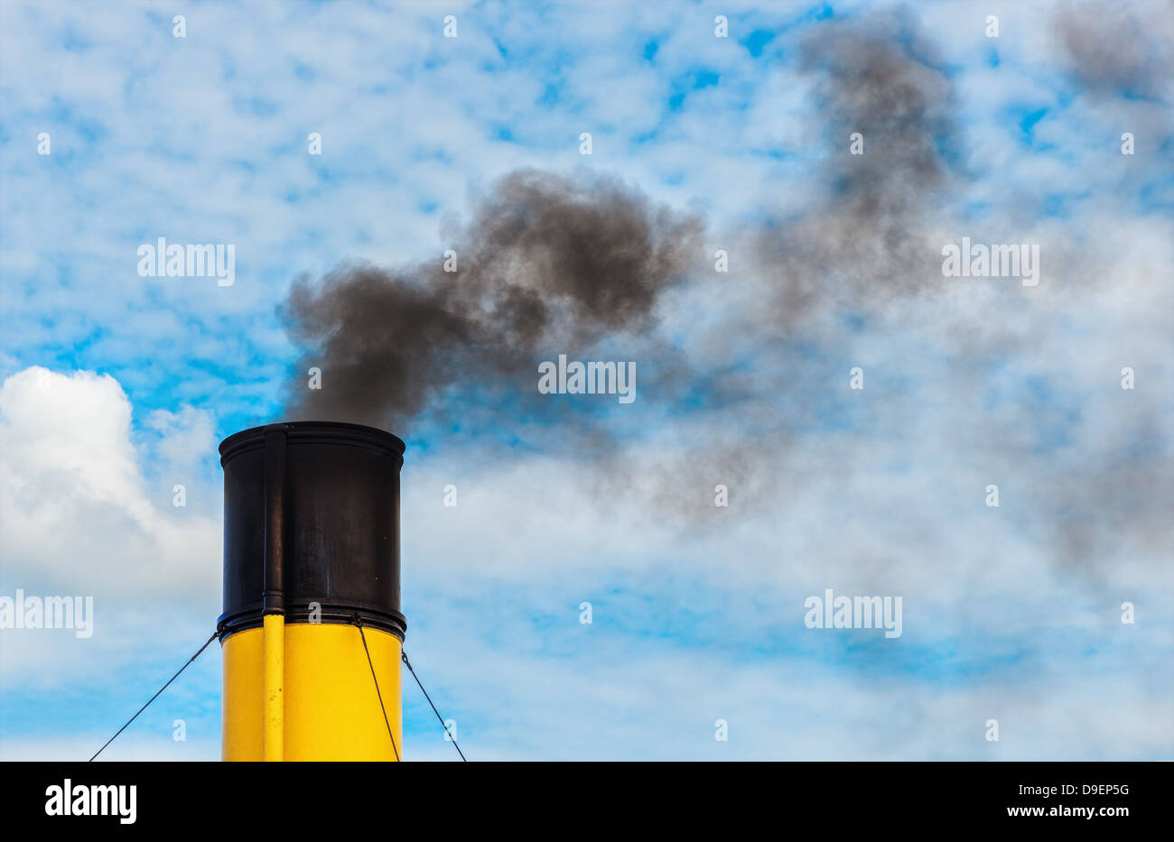 Chimney from steamboat with black coal smoke, yellow and black chimney