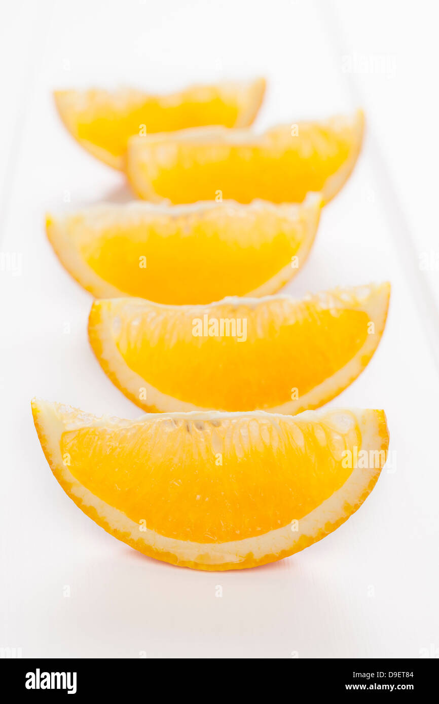 Orange wedges or slices on a white background with soft shadows. Stock Photo