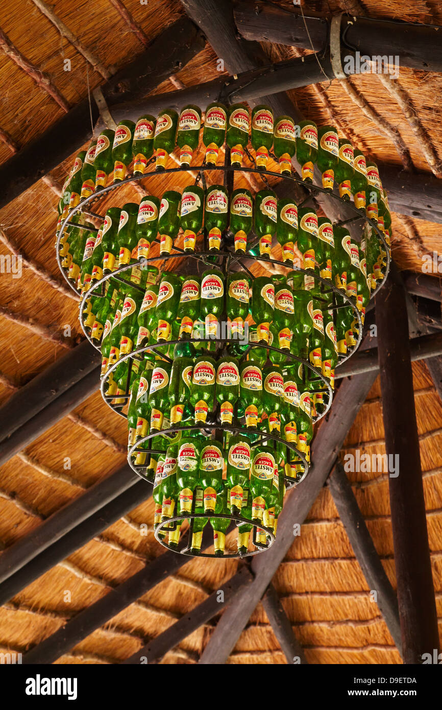 Beer bottle chandelier, at open-air bar, Planet Baobab, Gweta, Botswana, Africa Stock Photo