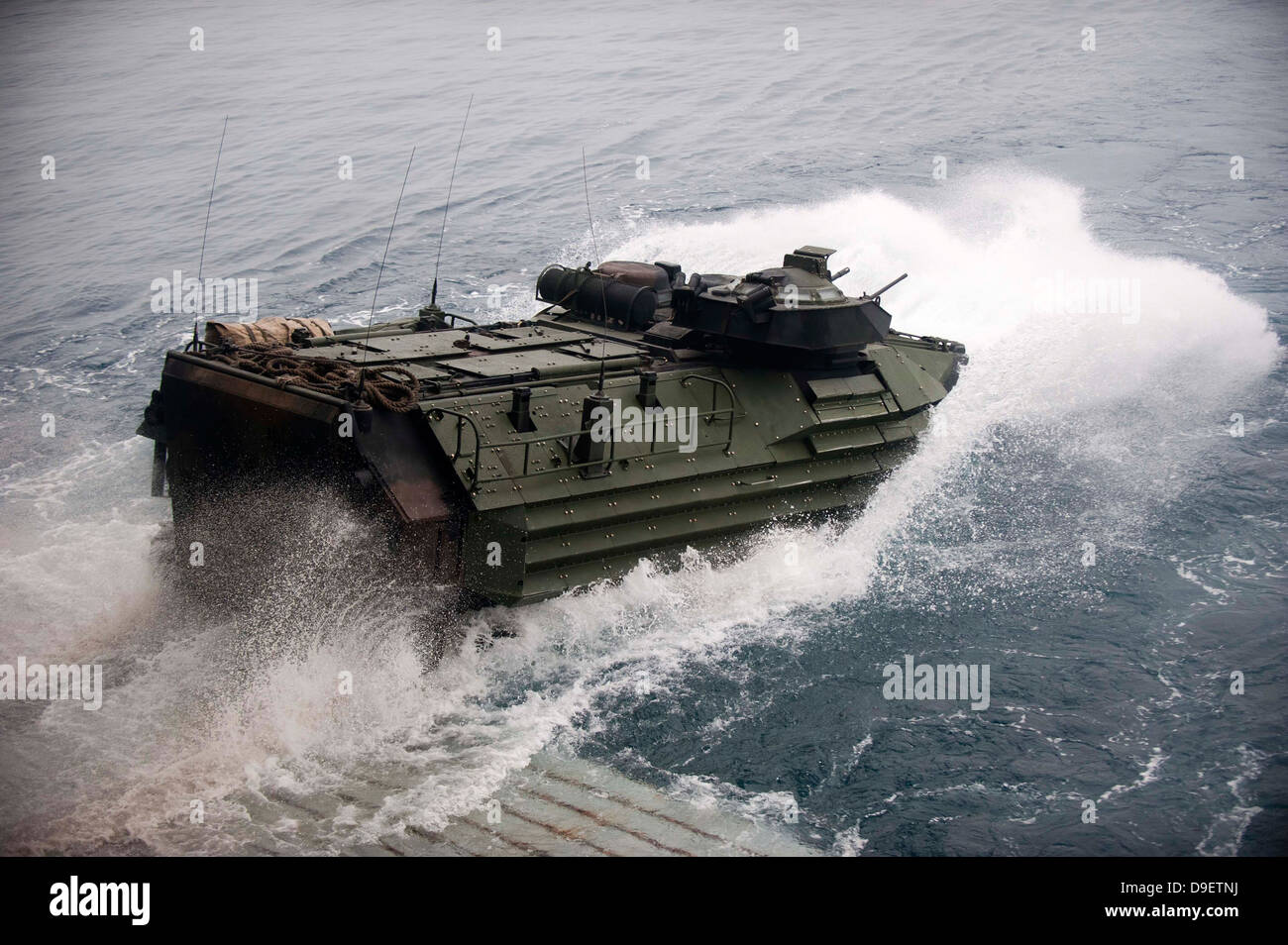 An amphibious assault vehicle departs the well deck of USS New Orleans. Stock Photo