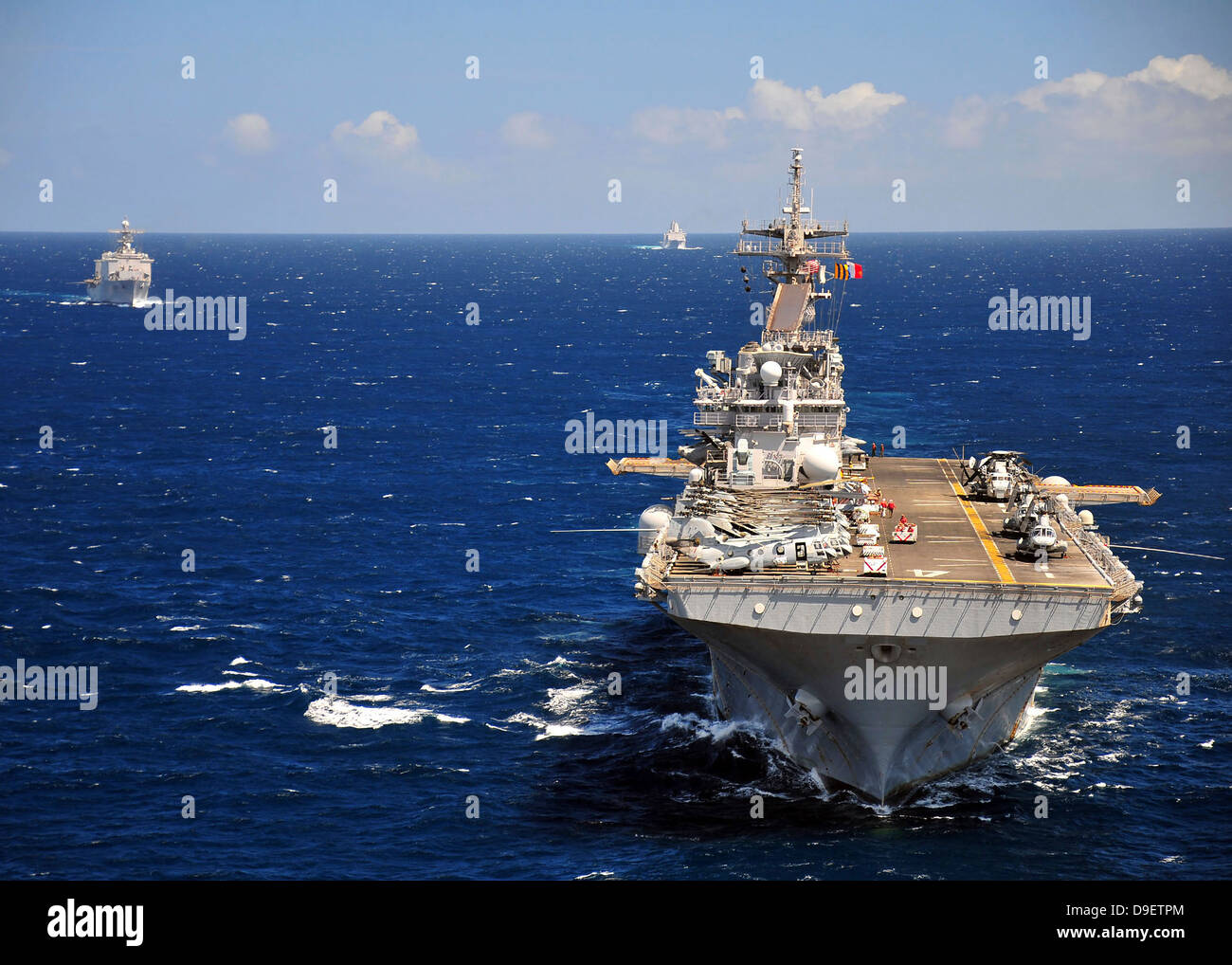 USS Boxer leads a convoy of ships in the Indian Ocean. Stock Photo