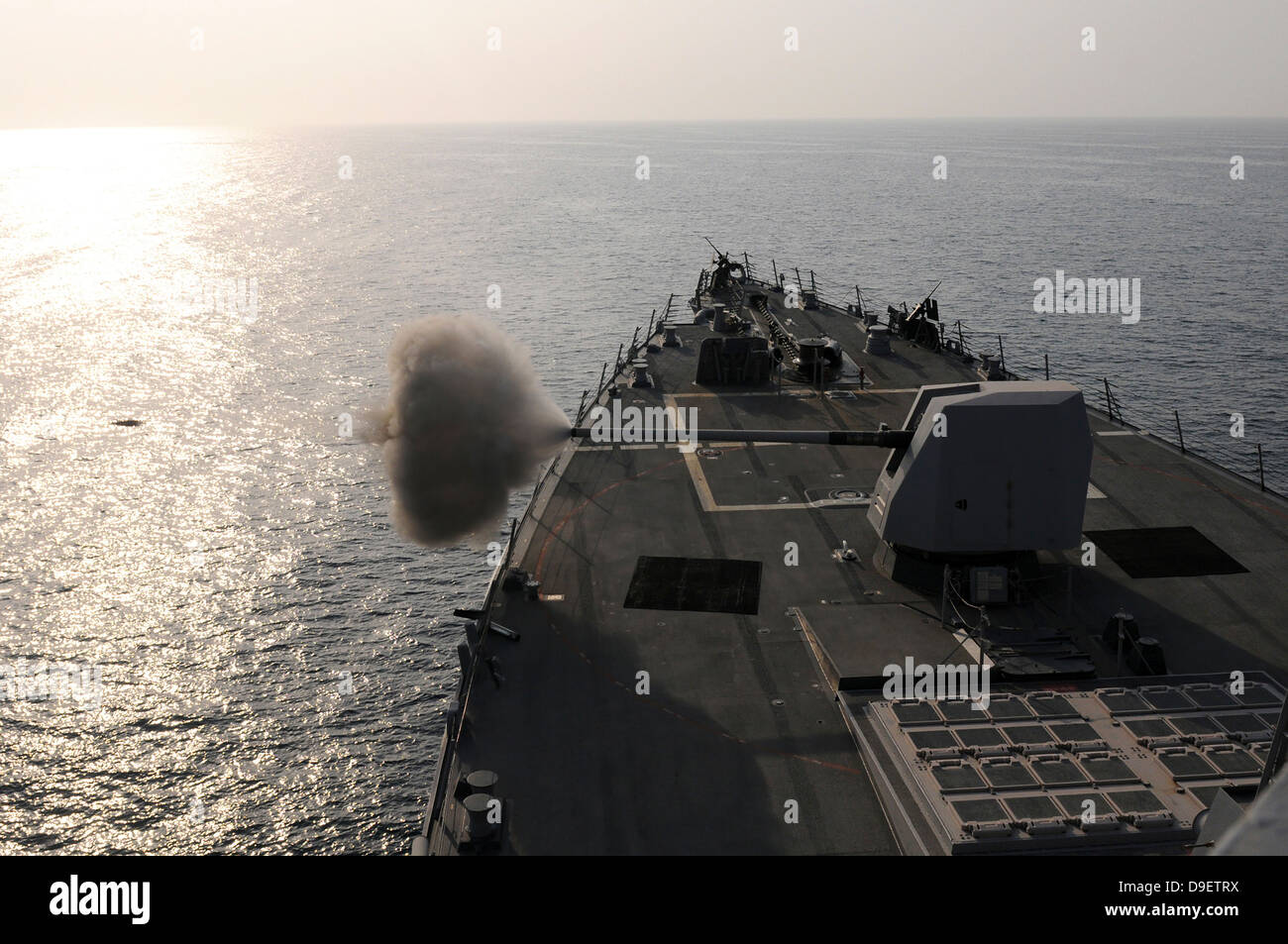 An Mk-45 lightweight gun is fired aboard guided missile destroyer USS Truxtun. Stock Photo