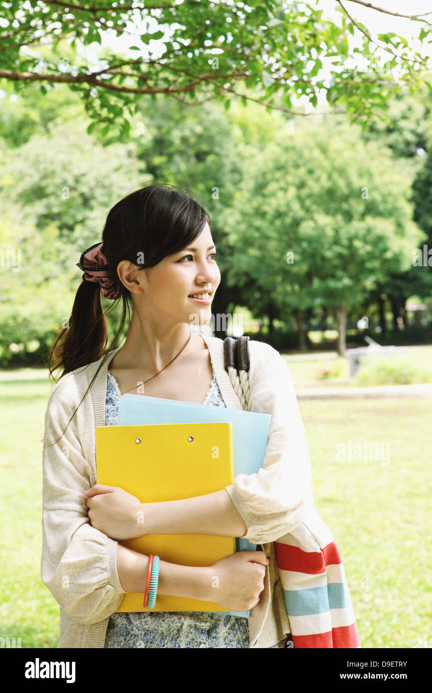 Female college student in a park smiling away Stock Photo