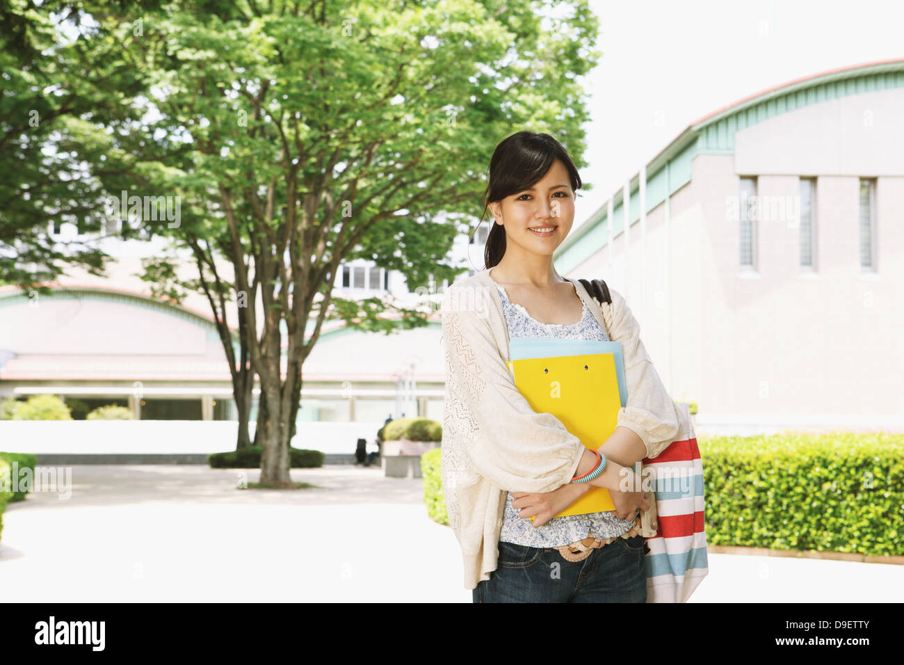Female college student in a campus smiling at camera Stock Photo