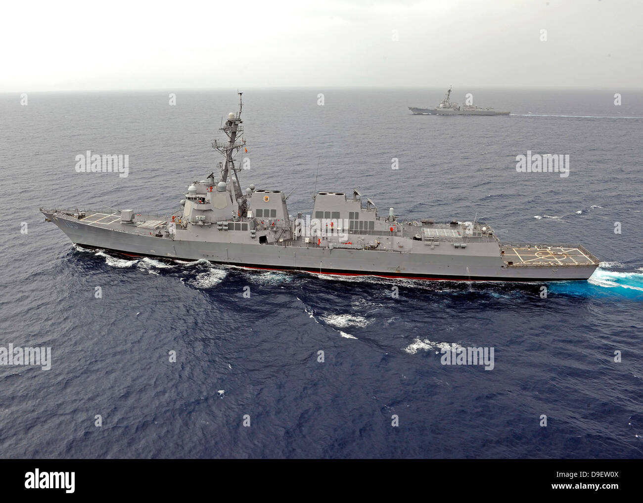 Guided missile destroyers USS Dewey and USS Pinckney transit the South China Sea. Stock Photo