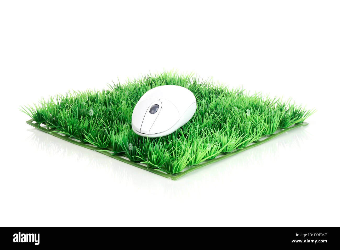 Computer mouse on art lawn computer mouse on artificial Grass Stock Photo