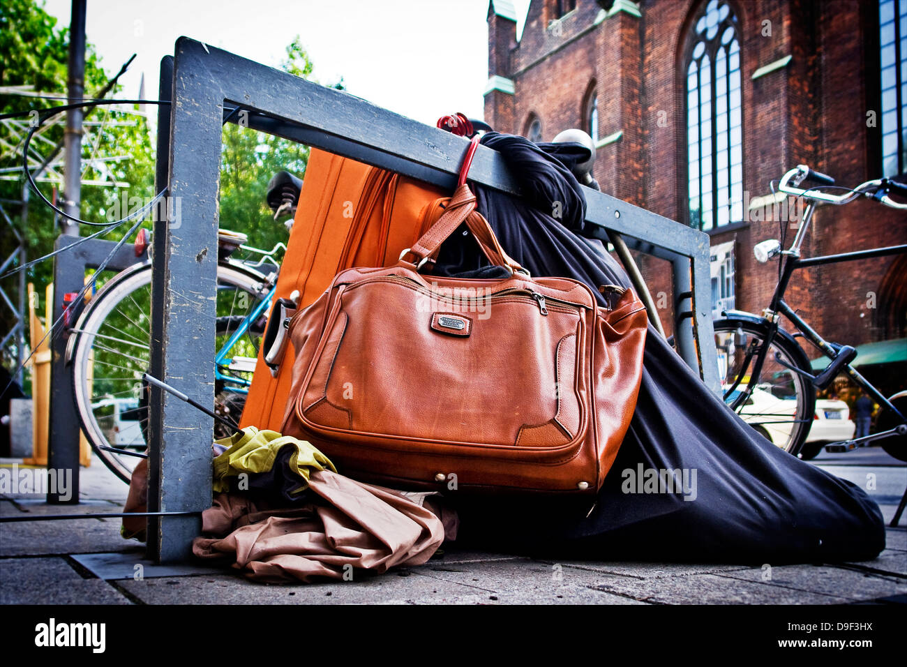 Belongings of a homeless, chained in a bicycle stand, Belongings of a homeless one, chained to a bicycle Stock Photo